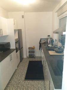 a kitchen with a sink and a counter top at LOVE Appartement partagé avec le proprietaire in Saint-Louis