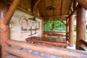 a porch with two wooden benches in a cabin at Casa Tibi in Praid