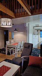 cocina y sala de estar con mesa y sillas en Arctic-maja A en Kittilä