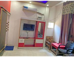 a room with a tv and a room with a table at Satkar Homestay, Saharanpur in Sahāranpur