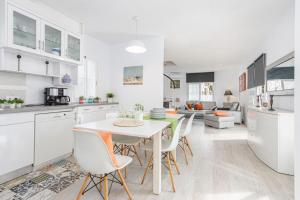 a kitchen and dining room with a table and chairs at Empurialola - Casa todo confort, con piscina, cerca de la playa y centro - 131 in Empuriabrava