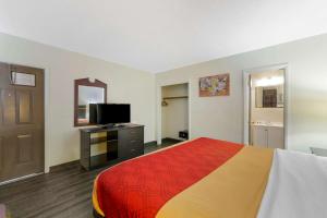 a hotel room with a bed and a television at Econo Lodge Hollywood - Ft Lauderdale International Airport in Hollywood