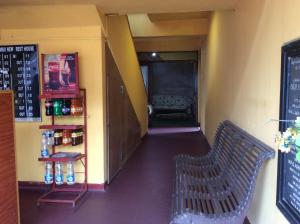 een gang van een restaurant met een bank in een kamer bij New Rest House Sea view Hotel in Negombo