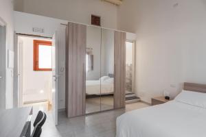カターニアにあるModern duplex with balcony by Wonderful Italyのベッドルーム1室(ベッド1台付)、大きなスライド式ガラスドアが備わります。