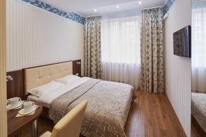 En eller flere senge i et værelse på Three Crowns Hotel