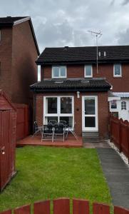格拉斯哥的住宿－Spacious home near Glasgow Green，房屋设有带桌椅的庭院