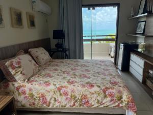 a bedroom with a bed with a view of the ocean at Casa na praia em condomínio de luxo - Porto Brasil Resort in Parnamirim +27 photos