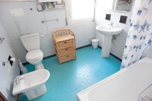 a bathroom with a white toilet and a sink at Casa Bruno e Iris in Levanto