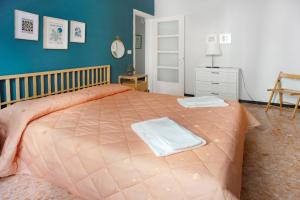 a bedroom with a large bed with two towels on it at Casa Caterina in Levanto