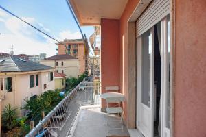 a balcony with a table and chairs on a building at Casa Caterina in Levanto