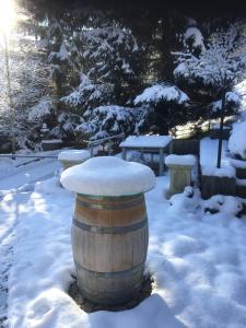 a barrel with snow on top of it in the snow at Leimernhof in Thörishaus