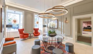 a living room with a glass table and chairs at Clayton Hotel Glasgow City in Glasgow