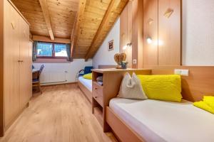 カディピエトラにあるNiederkoflhof Wollbachのベッドとデスクが備わる小さな客室です。