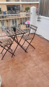 a pair of chairs and a table on a patio at Hotel Teide in El Arenal