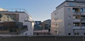 a white building next to two tall buildings at Sylter-Besserburg-App-7 in Westerland (Sylt)
