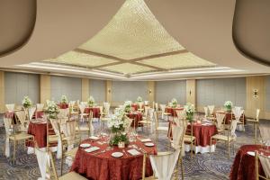 a banquet hall with tables and chairs in a room at Vivanta Meghalaya Shillong in Shillong