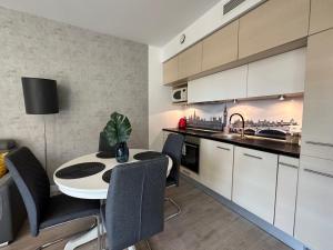 a kitchen with a table and chairs in a room at Apartament Centrum Krawiecka 2 in Wrocław