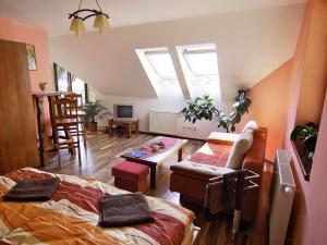 a bedroom with a bed and a living room at Villa Raj in Hrabušice