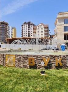 a fountain in the middle of a city with buildings at Apartman Stojanovic 1 in Zlatibor