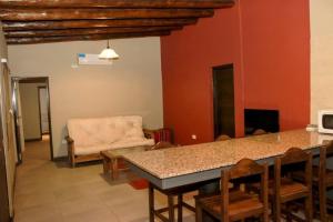 a living room with a table and a couch at Cabañas Entre Hileras in Ciudad Lujan de Cuyo