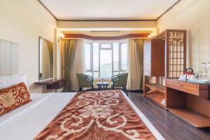 Ένα ή περισσότερα κρεβάτια σε δωμάτιο στο Summit Lillium Hotel & Spa