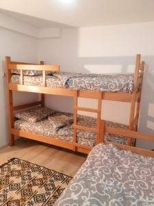 a room with two bunk beds and a rug at SIMIĆ planinska kuća in Divčibare