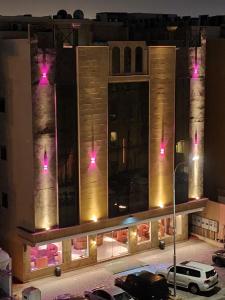 a building with pink lights on the side of it at نسيم العليا in Al Khobar