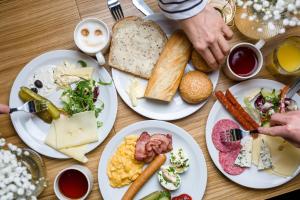 a wooden table with plates of food on it at Hotel Molo in Sopot
