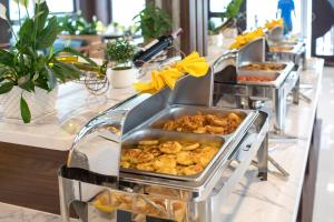a buffet line with many trays of food at Cat Ba Valentine in Cat Ba