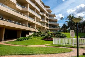 a large apartment building with a walkway and a street light at 406 Les Mouettes in Ballito