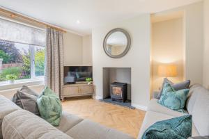 a living room with two couches and a fireplace at The Bank House- Luxury 3 bed cottage with hot tub! in Silverdale