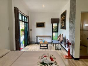 a bedroom with a bed with two swans on it at Oneandaman Resort in Khao Lak