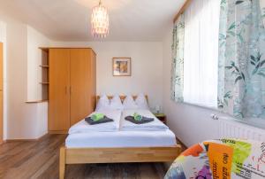 a small bedroom with a bed and a window at Haus Pitzer/Apartments Troicher in Schladming