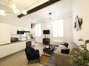 a living room with a couch and a kitchen at 06R - Beau T2 moderne - Vieux Nice in Nice