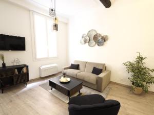 a living room with a couch and a tv at 06R - Beau T2 moderne - Vieux Nice in Nice