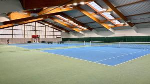 a tennis court with two tennis in a building at Familien Hotel Krainz in Loipersdorf bei Fürstenfeld
