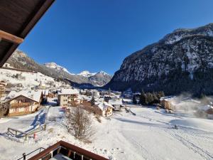 a small town in the mountains with snow on the ground at Cèsa Cherpei - Pet Friendly in Campitello di Fassa