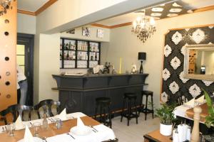 a dining room with a bar in a restaurant at Hotel Gloria Budapest City Center in Budapest