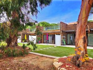 a large brick house with a yard at La villa Roméo, piscine et spa in Sainte-Maxime