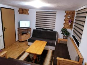 a living room with a couch and a table at Apartman Miron Pale in Pale