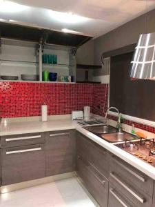 a kitchen with a sink and a counter top at Beautiful house in Sabana Basora Aruba! in Savaneta