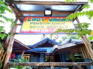 a sign for a restaurant in front of a house at LADY GHAGHA ROOM RENTALs in San Vicente