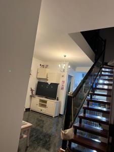a staircase leading to a living room with a flat screen tv at COCO in Puerto del Rosario