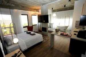 a bedroom with a bed and a desk and a tub at G.R City Heart in Nicosia