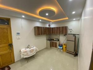 a kitchen with a sink and a refrigerator at One bed lovely apartment in Rawalpindi