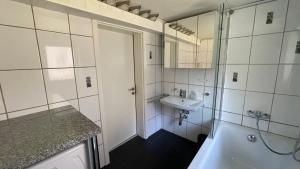 a bathroom with a tub and a sink and a shower at Alte Schmiede in Langelsheim