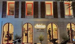 a store front of a building with windows at Leiden Homestay&Cafe' in Ho Chi Minh City