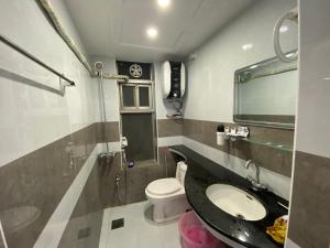 a bathroom with a sink and a toilet at One bed lovely apartment in Rawalpindi