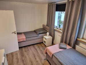 a living room with a couch and a window at Gästehaus-Ferienwohnung-Appartement mit Terrasse - Nähe Kliniken/ Herzzentrum in Bad Oeynhausen