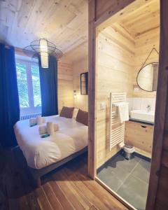 a bedroom with a bed in a wooden cabin at Hôtel Restaurant "La Petite Auberge" in Bourg-Saint-Maurice +24 photos